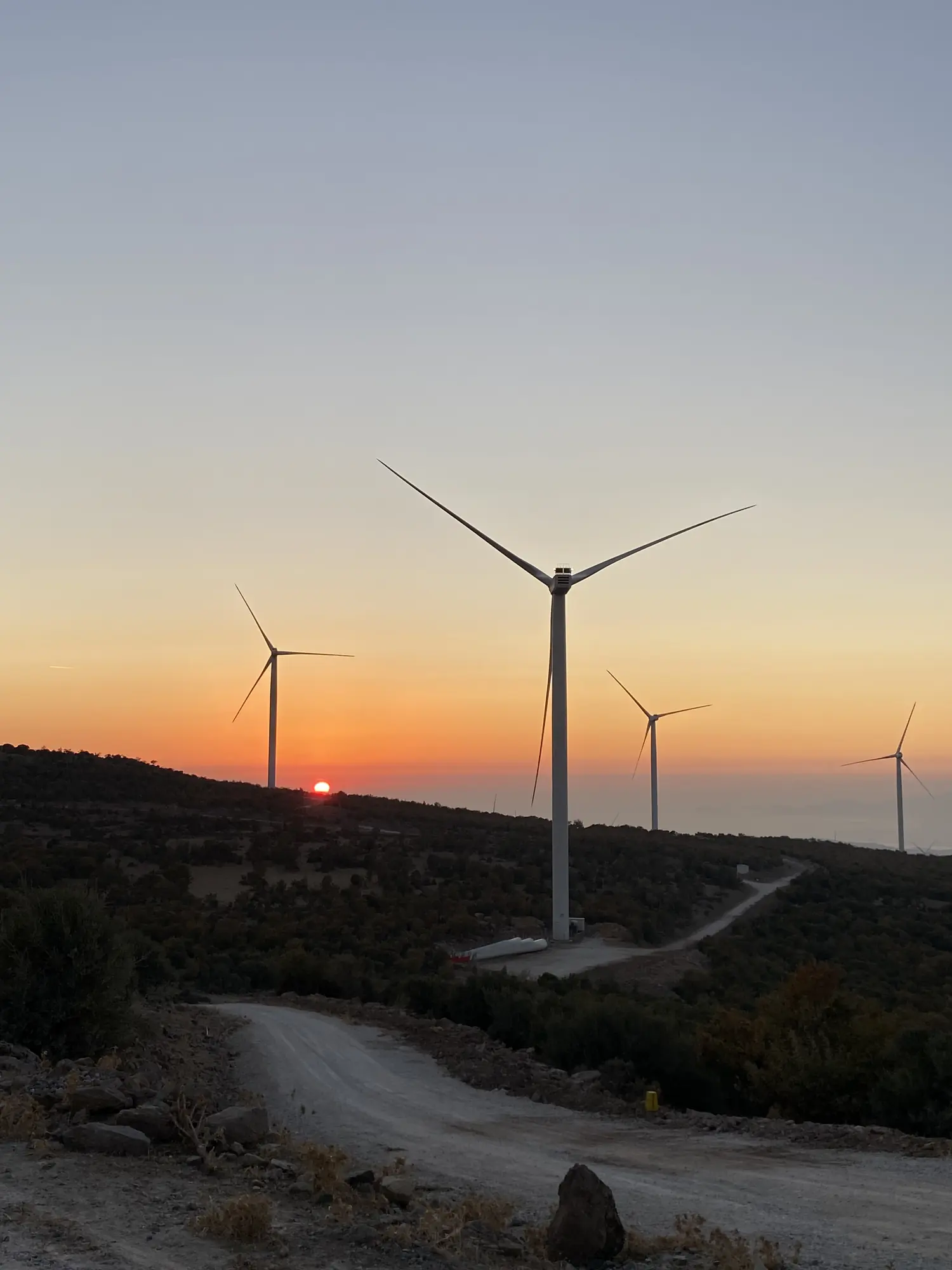 A wind turbine at sunset, photographed on site